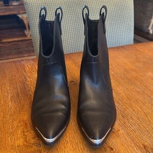 Size 7 1/2 black short heeled booties with a silver finish on the toe